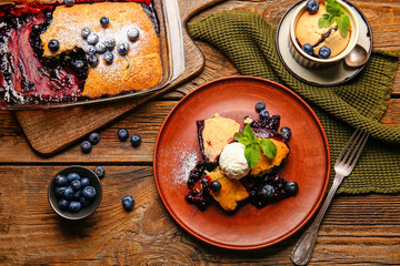 Composition with blueberry cobbler and ice cream on wooden background