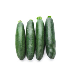 Fresh zucchini squashes on white background