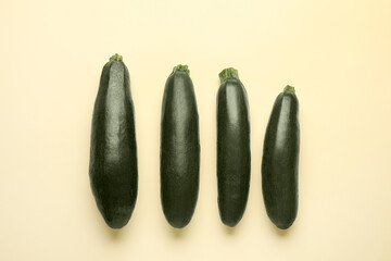 Fresh zucchini squashes on color background