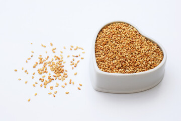 Roasted sesame seeds in ceramic bowl of heart shape