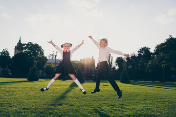 Fototapeta na wymiar Photo of energetic sportive friends schoolchildren jump wear bag school uniform nature park outdoors