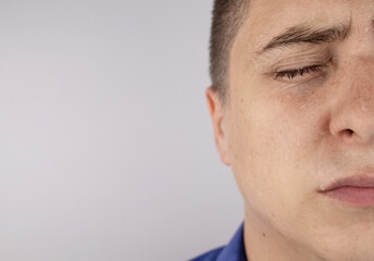 An office worker in a blue shirt looks at the camera. He covered in sweat stains. The man has a lot...