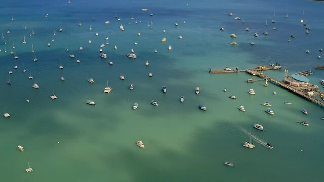 Aerial view of the marina lot. Docked sailboats and catamarans in yacht club. Lack of tourists due to lockdown of tropical countries. The consequences of coronavirus for the tourism business.