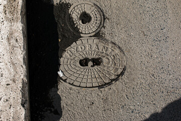 Close-up of a manhole cover, Hydrant in Gray gravel stones for the construction industry. Geometric...