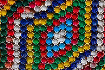 A lot of multi-colored caps from under plastic bottles close-up.