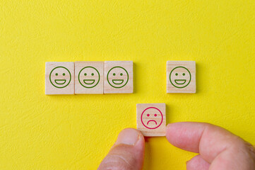 Wooden blocks with facial expression of feedback. Customer evaluation and satisfaction concept