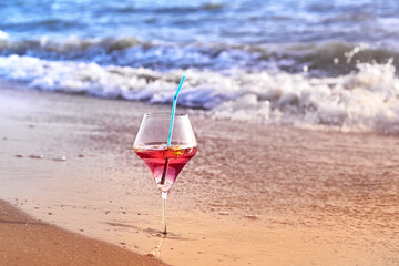 Wine glass with a cocktail by the sea.