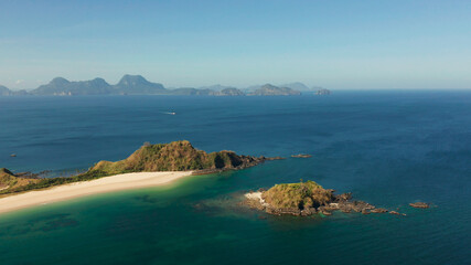Fototapeta na wymiar Blue sea and tropical beach, aerial drone. Nacpan, El Nido, Palawan, Philippine Islands. Seascape with tropical beach and islands. Summer and travel vacation concept