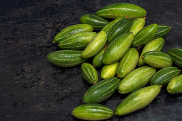 Few fresh organic Pointed gourd on a black background with selective focus