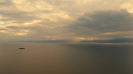 Colorful bright clouds during sunset over the sea, aerial view. Sunset over ocean. Seascape, Summer and travel vacation concept, Moalboal, Philippines.