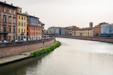 Fototapeta na wymiar river arno flowing through the oldtown of Pisa, Tuscany