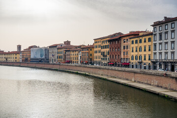 Naklejka na ściany i meble river arno flowing through the oldtown of Pisa, Tuscany