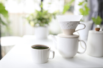 White coffee cup and coffee drip pot