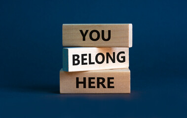 You belong here symbol. Wooden blocks with words 'You belong here' on beautiful grey background....
