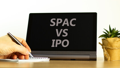SPAC vs IPO symbol. Tablet with words 'SPAC, special purpose acquisition company vs IPO, initial...