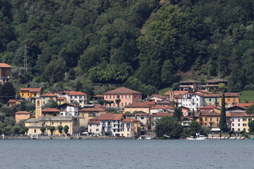 Fototapeta na wymiar Oliveto Lario , Como , Italy : View of the beautiful lake with buildings and skyline