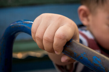 Child hand holding handlebar steel