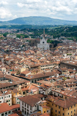 Fototapeta na wymiar Red rooftops of Florence with the Santa Croce Basilica in the background.