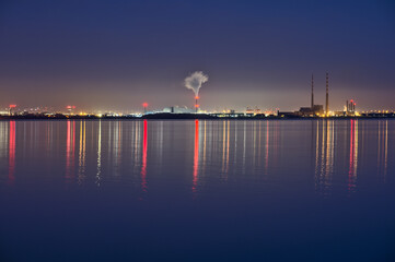 Spectacular early morning view of Dublin Waste to Energy (Covanta Plant), Poolbeg CCGT and Pigeon House Power Station view from Dun Laoghaire Harbor with light reflection in water, Dublin, Ireland
