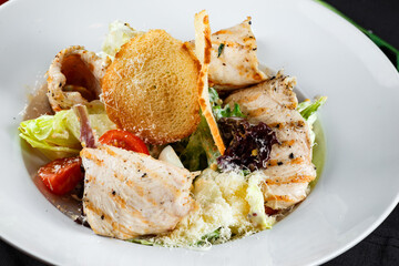 caesar with chicken in a white plate