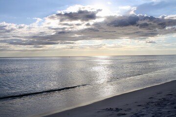 Beach with Clouds, Blue Sky, and Sunlight