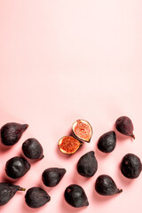 Fresh whole and sliced fig isolated on pastel pink background, top view. Ripe sweet figs . Healthy mediterranean fig fruit.