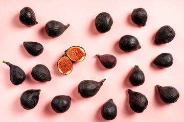 Fresh whole and sliced fig isolated on pastel pink background, top view. Ripe sweet figs . Healthy mediterranean fig fruit.