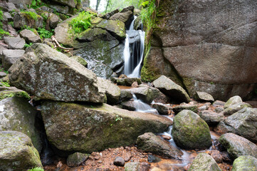 Long exposure of Burn O' Vat waterfall, Deeside, Aberdeenshire, Scotland. Rocks in foreground. This is a well known walk.
