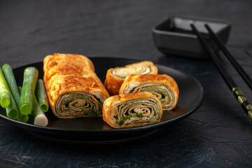 Japanese kitchen. Tamagoyaki - Japanese omelet, rolled several layers of fried egg