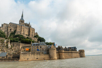 The famous Mont Saint-Michel Abbey at sunrise at high tide in the Manche department, Normandy region, France