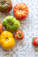 Heirloom tomatoes on blue tile