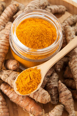 Fresh organic root and turmeric powder - Curcuma longa; Healthy Food.