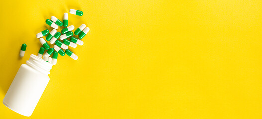 Pills and medicine bottles on a yellow background,All kinds of drugs to be put into the medicine bottle on the yellow background