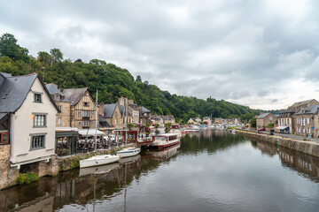 Fototapeta na wymiar Houses and boats on the Rance river in Dinan medieval village in French Brittany, France