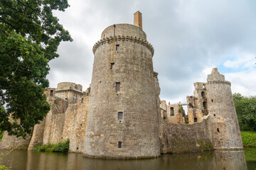Fototapeta na wymiar Castle of the Hunaudaye is a medieval fortress, beautiful walls surrounded by water, French Brittany. Historical Monument of France