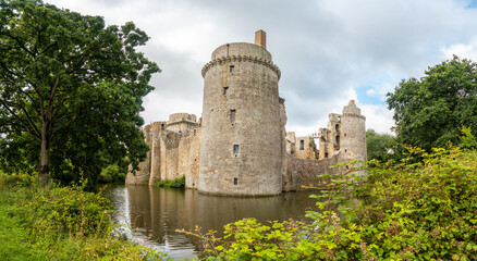 Fototapeta na wymiar Castle of the Hunaudaye is a medieval fortress, beautiful walls surrounded by water, French Brittany. Historical Monument of France