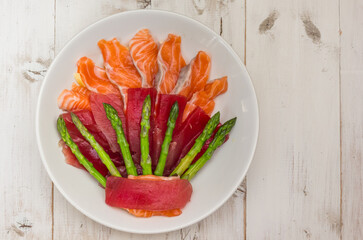 Japanese sashimi with tuna and salmon on a white plate