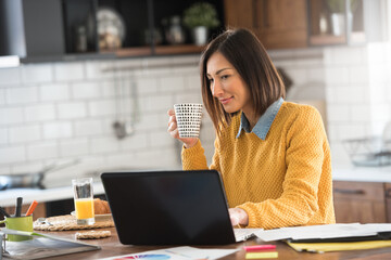 Freelance woman working in home office with laptop computer. Flexible workspace and working time.