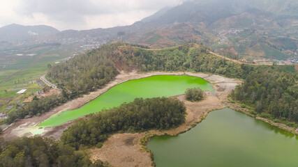 volcanic sulfur lake telaga warna in dieng plateau, java Indonesia. mountain tropical landscape lake with green water among mountains. this lake is one mainstay tourist destinations in Wonosobo