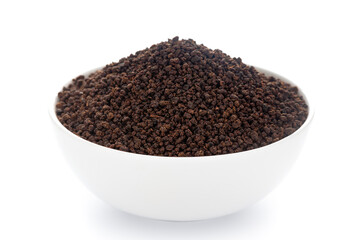 Close-Up of organic black tea small cut   in white ceramic bowl over white background