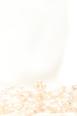 Obraz na płótnie Canvas decorative white pearls nestled in luxurious silk