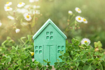 Green House on nature. Real Estate concept. Small House on Lawn. Sustainable house.