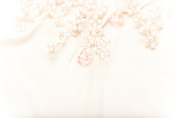 Obraz na płótnie Canvas white pearls and pink jewels nestled in white silk