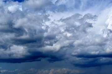 Blue and white cumulus clouds before a thunderstorm