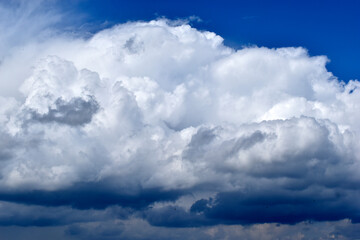 Blue and white cumulus clouds before a thunderstorm