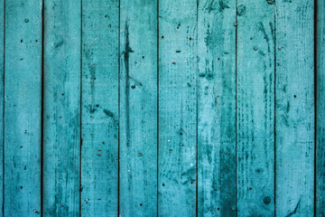 Old weathered turquoise colored wooden wall