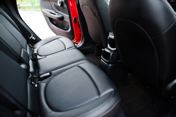 Interior of back seats red city car. Small car for cities.