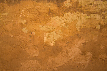 Old and dirty yellowish wall texture background with broken pieces.