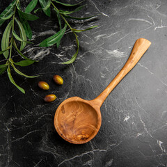 wooden spoons on the table with olives