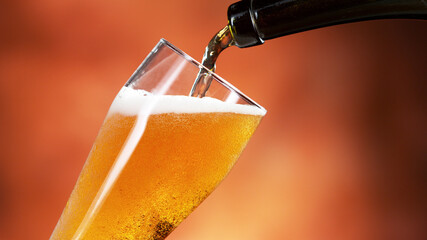 Pouring beer into pint, close-up.